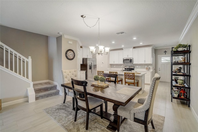 dining space with an inviting chandelier, stairs, visible vents, and crown molding