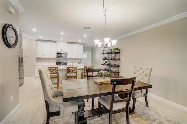 dining space with baseboards, visible vents, crown molding, a chandelier, and recessed lighting