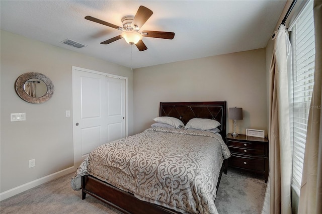 bedroom with baseboards, visible vents, ceiling fan, and carpet flooring