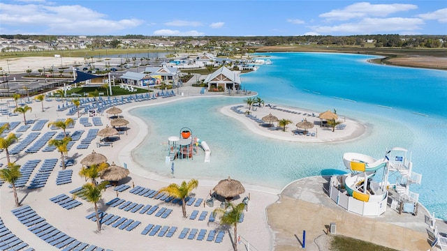 drone / aerial view with a beach view and a water view