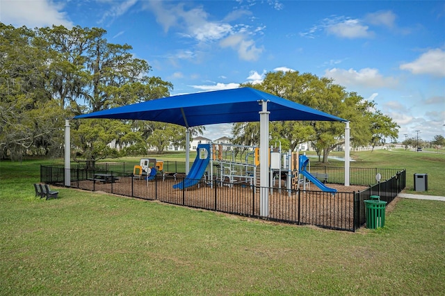 community playground with a yard and fence