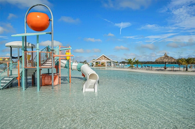 community playground with a water view and a beach view