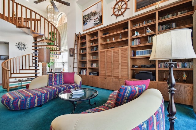 living room with ceiling fan with notable chandelier and carpet flooring