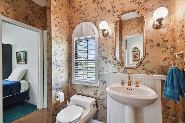 bathroom with toilet and tile floors