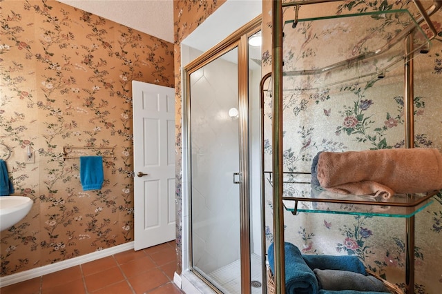 bathroom featuring a shower with door and tile floors