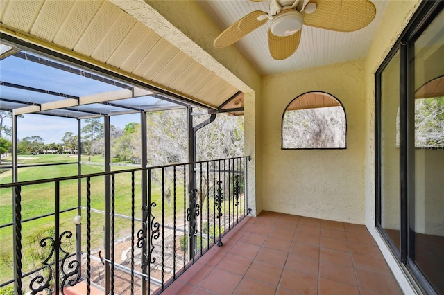 unfurnished sunroom featuring ceiling fan