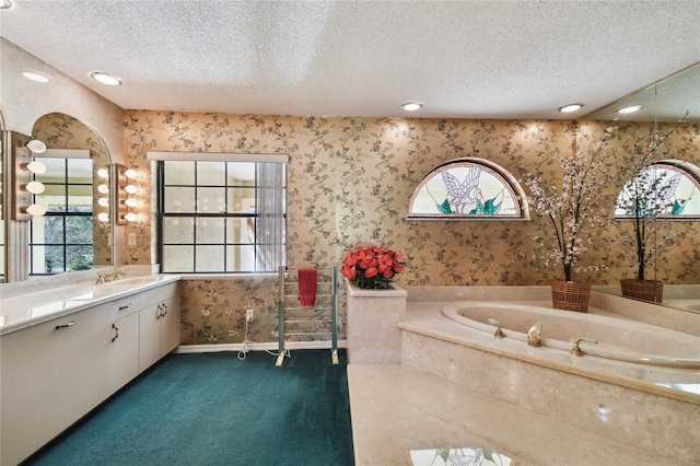 bathroom featuring a textured ceiling, a wealth of natural light, and vanity