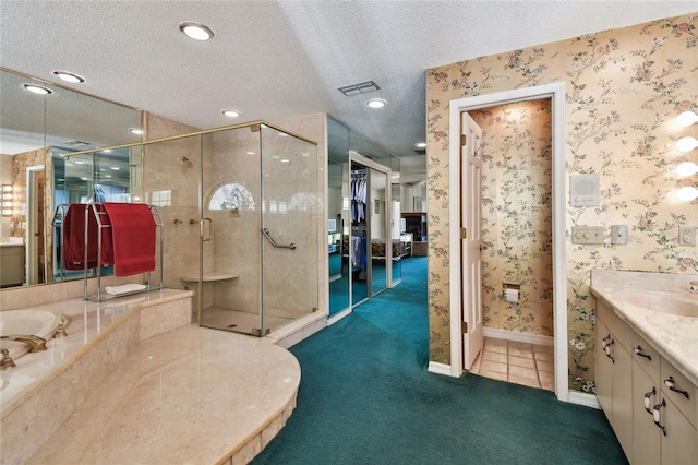 bathroom featuring tile flooring, vanity, a shower with door, and a textured ceiling