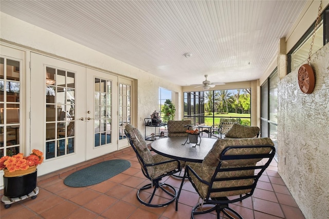 sunroom featuring ceiling fan and french doors