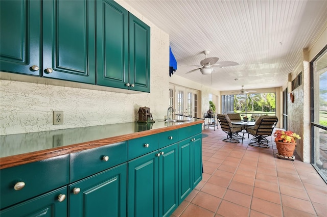 kitchen featuring french doors, ceiling fan, sink, and light tile flooring