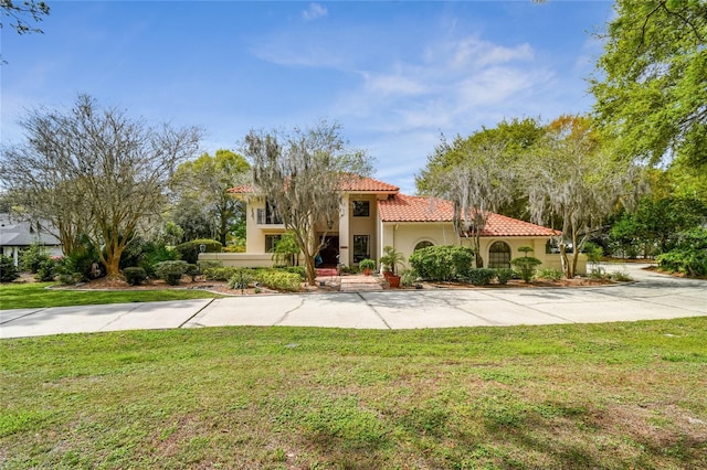 mediterranean / spanish-style home with a front yard