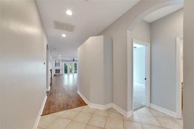 corridor with light hardwood / wood-style floors