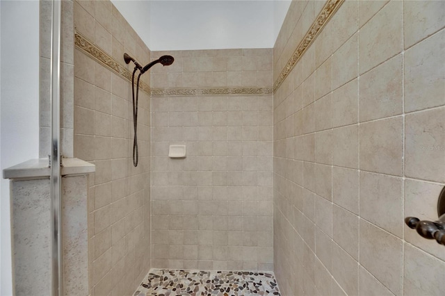 bathroom with a tile shower