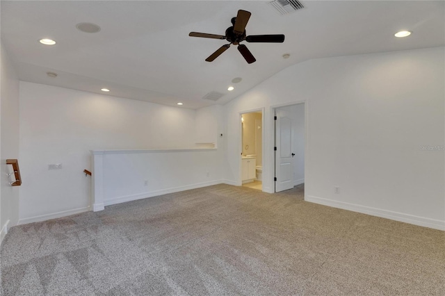 carpeted empty room featuring ceiling fan and lofted ceiling