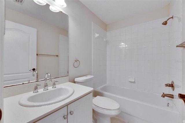 full bathroom with toilet, vanity, and tiled shower / bath