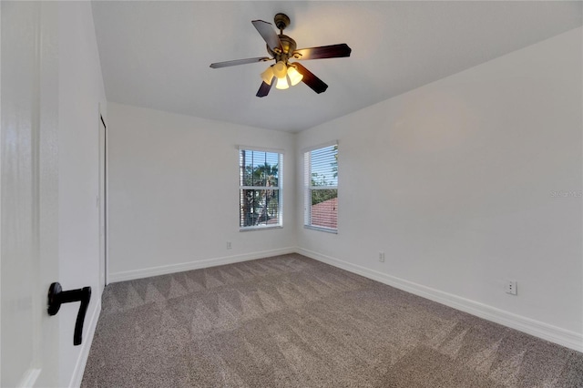 carpeted spare room with ceiling fan