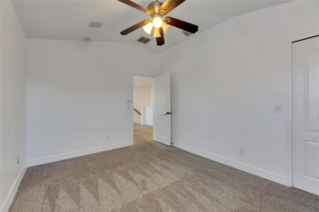 carpeted spare room with ceiling fan and lofted ceiling