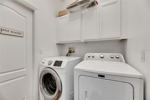 laundry room with cabinets and separate washer and dryer