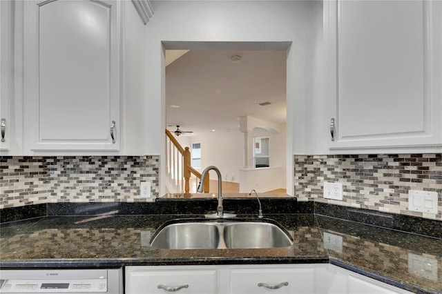 kitchen with backsplash, dark stone counters, sink, dishwasher, and white cabinetry