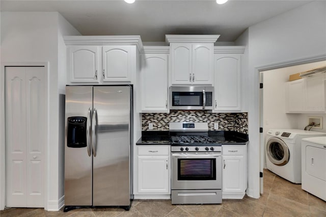 kitchen with backsplash, washer and clothes dryer, white cabinets, and stainless steel appliances