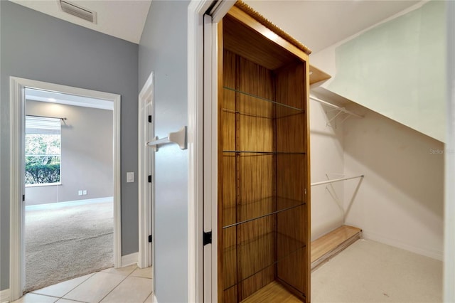 spacious closet featuring light carpet