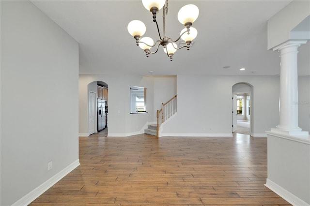 interior space with wood-type flooring and an inviting chandelier