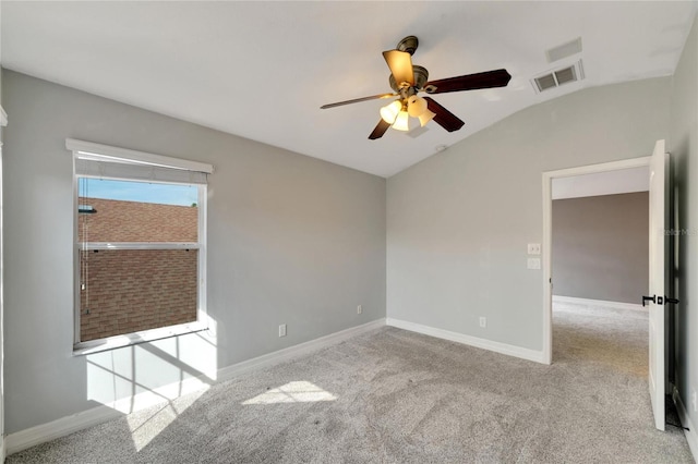 carpeted empty room with ceiling fan and lofted ceiling