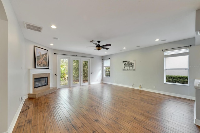 unfurnished living room with hardwood / wood-style floors, plenty of natural light, and ceiling fan