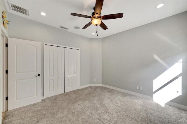 unfurnished bedroom featuring carpet flooring, a closet, and ceiling fan