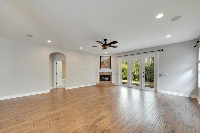 unfurnished living room with ceiling fan and light hardwood / wood-style flooring