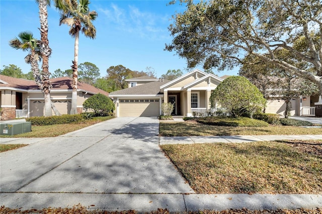 view of front of property featuring a front lawn, covered porch, and a garage