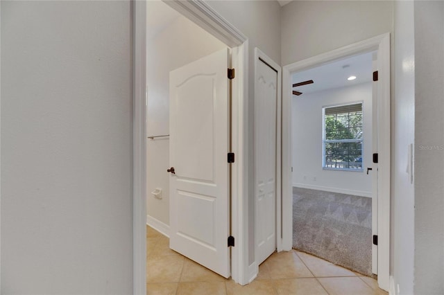 hallway with light colored carpet