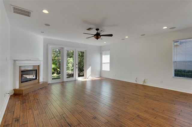 unfurnished living room featuring hardwood / wood-style flooring and ceiling fan