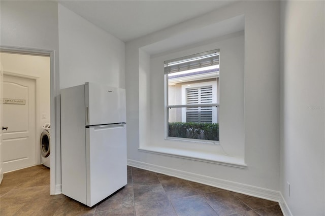 kitchen with white fridge and washer / clothes dryer