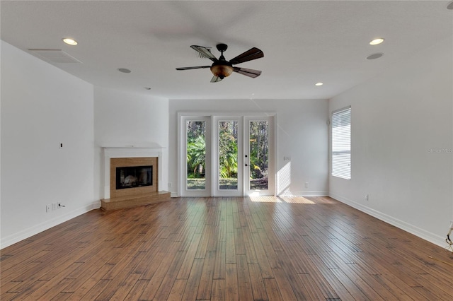 unfurnished living room featuring french doors, hardwood / wood-style flooring, and ceiling fan