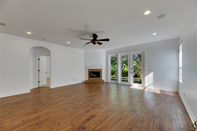 unfurnished living room with ceiling fan and hardwood / wood-style floors