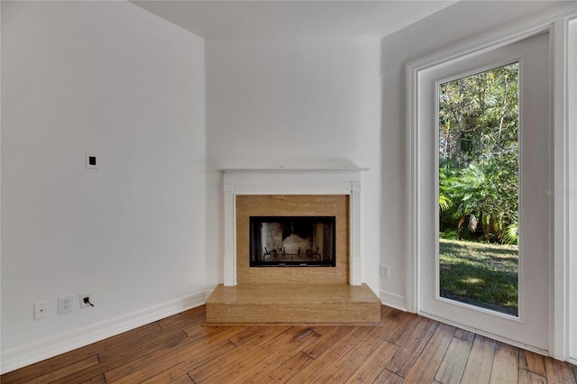 unfurnished living room with hardwood / wood-style flooring