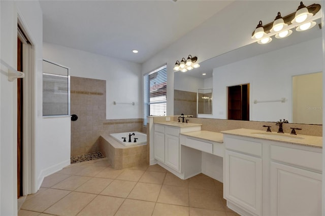 bathroom featuring plus walk in shower, vanity, and tile patterned floors