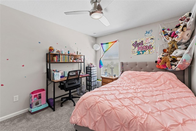 carpeted bedroom featuring ceiling fan and a textured ceiling