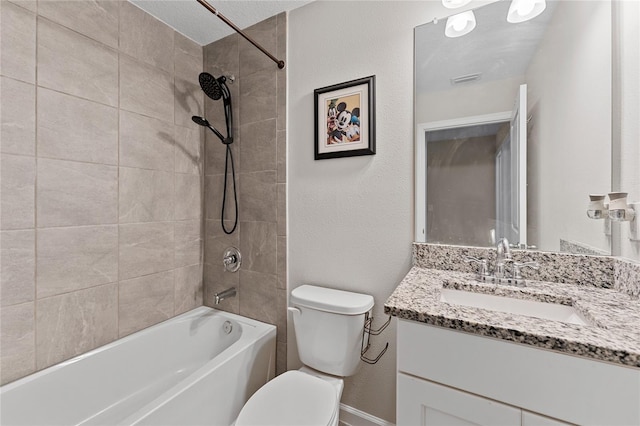 full bathroom featuring tiled shower / bath combo, vanity, a textured ceiling, and toilet