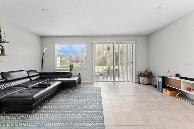 tiled living room featuring a textured ceiling