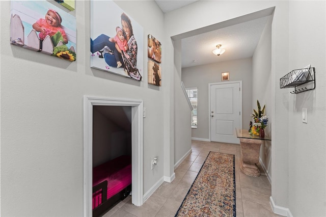 tiled foyer featuring a textured ceiling