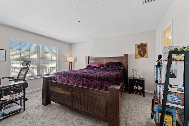 carpeted bedroom featuring a textured ceiling