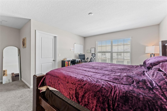 carpeted bedroom featuring a textured ceiling