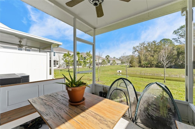 sunroom / solarium featuring ceiling fan