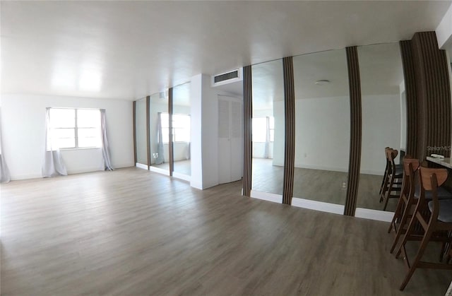 empty room with light hardwood / wood-style flooring