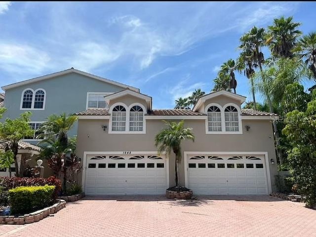 mediterranean / spanish house with a garage