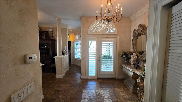 tiled entrance foyer with a chandelier, ornate columns, and ornamental molding