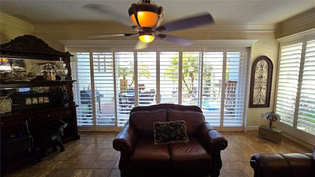 tiled living room featuring a healthy amount of sunlight, ornamental molding, and ceiling fan