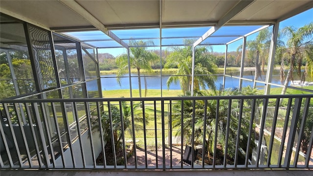 unfurnished sunroom with a water view